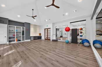 Fitness studio with yoga room, cardio and strength areas